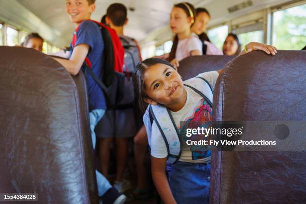 happy native american girl riding on school bus - constituency stock pictures, royalty-free photos & images