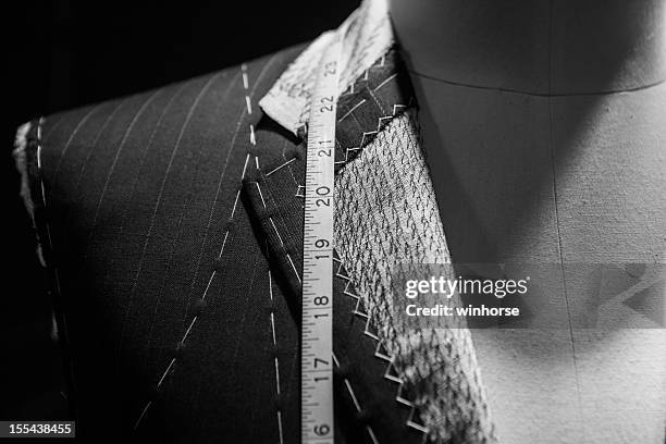 man wearing a suit close-up with tape measure around neck - mannequin stock pictures, royalty-free photos & images