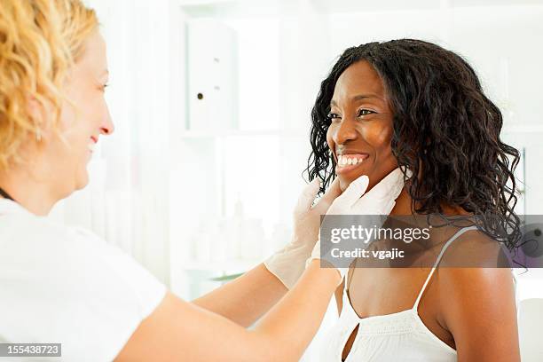 mid age african woman visit doctor. - thyroid exam stock pictures, royalty-free photos & images