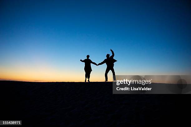 aktive senior - old couple jumping stock-fotos und bilder