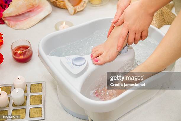 water massage female feet - foot spa stock pictures, royalty-free photos & images
