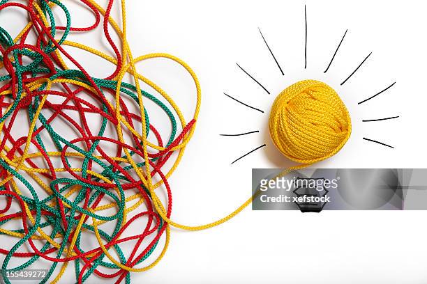 yellow ball of wool with pen lines like lightbulb - ingewikkeldheid stockfoto's en -beelden
