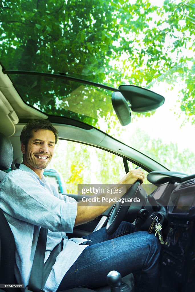 Cheerful driver in his car