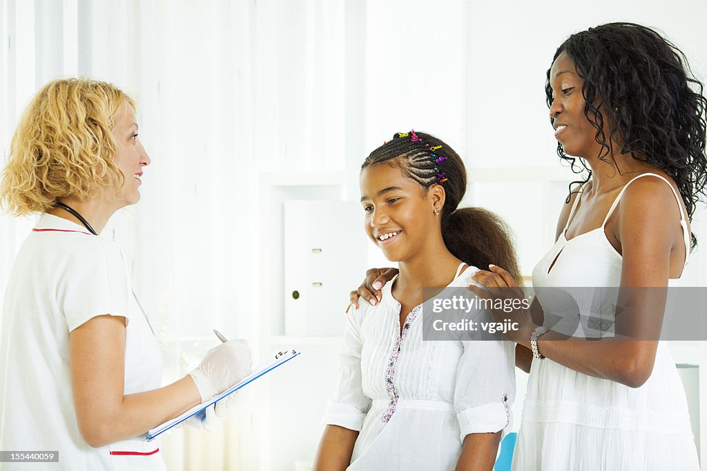 Early Teenage Girl with mother Visit Doctor.