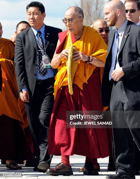 Tibetan spiritual leader the Dalai Lama arrives to bless the Anacostia River in Washington with sand from a mandala mixed with water during a...