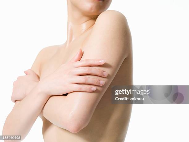 the naked woman holds both arms - oksel stockfoto's en -beelden