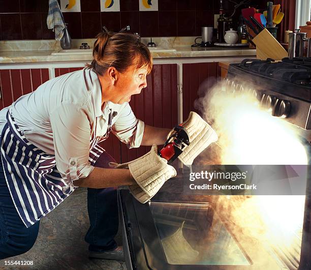 woman and oven fire while cooking in the kitchen - fire extinguisher stock pictures, royalty-free photos & images