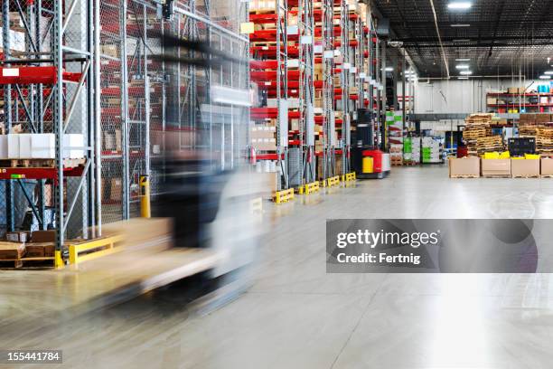 moving forklift in a warehouse - material handling stock pictures, royalty-free photos & images