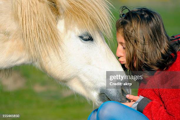 young girl with shetland pony - miniature shetland pony stock pictures, royalty-free photos & images