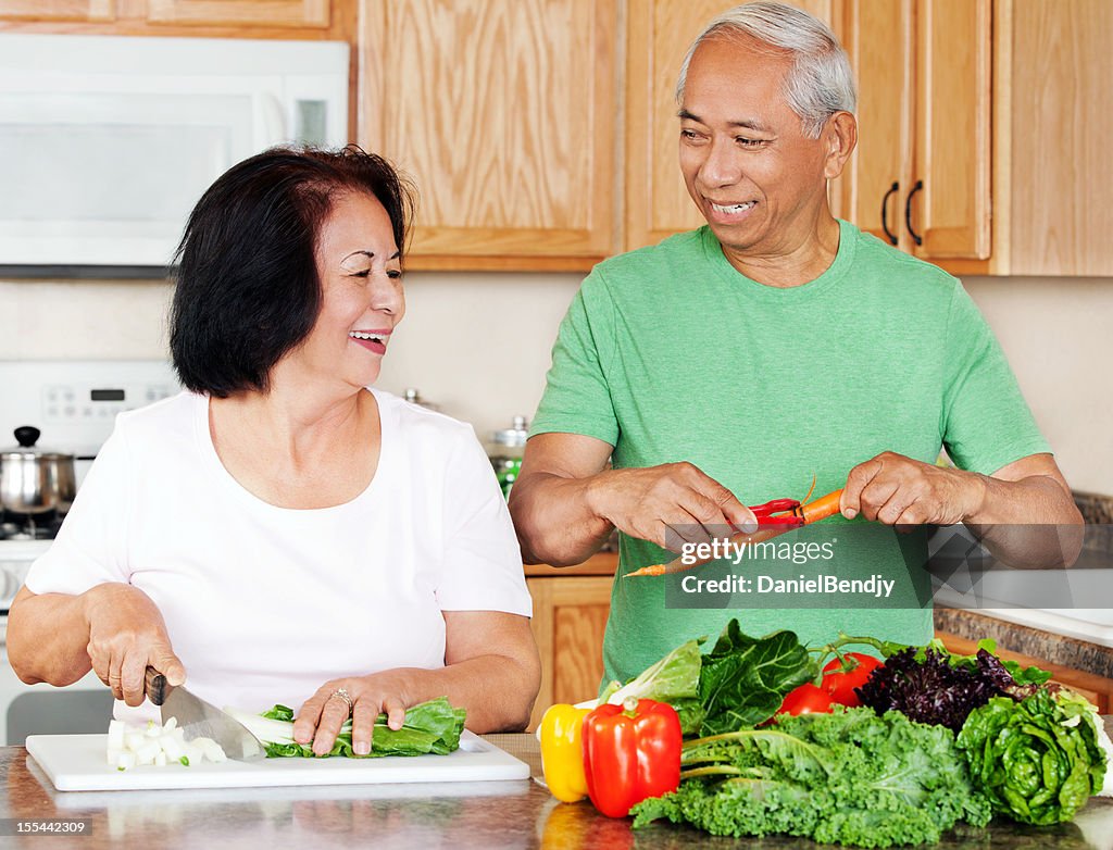 Mature Asian Couple Preparing Meals in the Kitchen