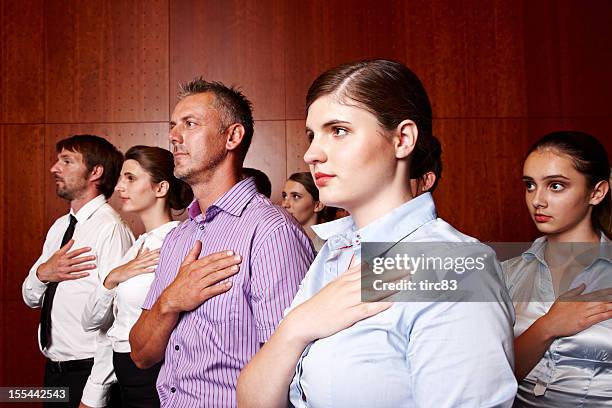 group of businessman and businesswomen hands on hearts - pledge stock pictures, royalty-free photos & images