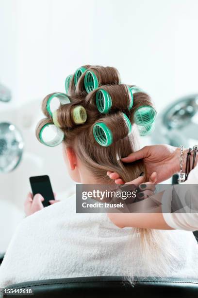 woman in a hair salon - hair curlers stock pictures, royalty-free photos & images