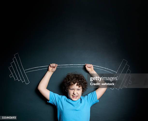 a little boy standing against a blackboard - young kid and barbell bildbanksfoton och bilder