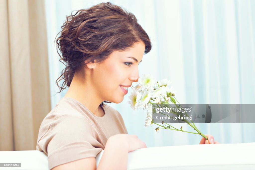 Close-up of an attractive young woman with flower