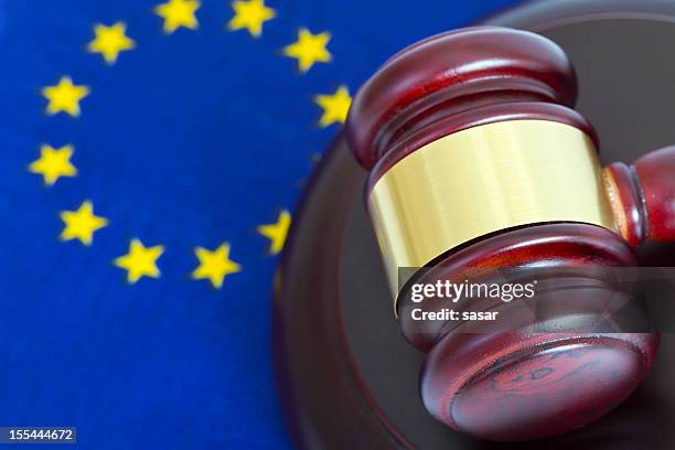 dark red gavel with gold stripe and eu flag on background  - european court of justice stock pictures, royalty-free photos & images