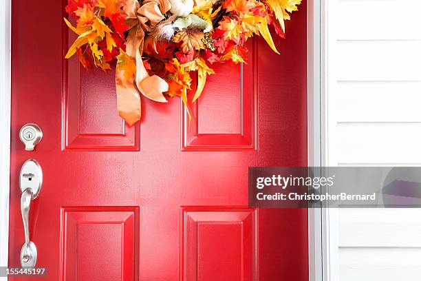 red door with autumn wreath - autumn wreath stock pictures, royalty-free photos & images