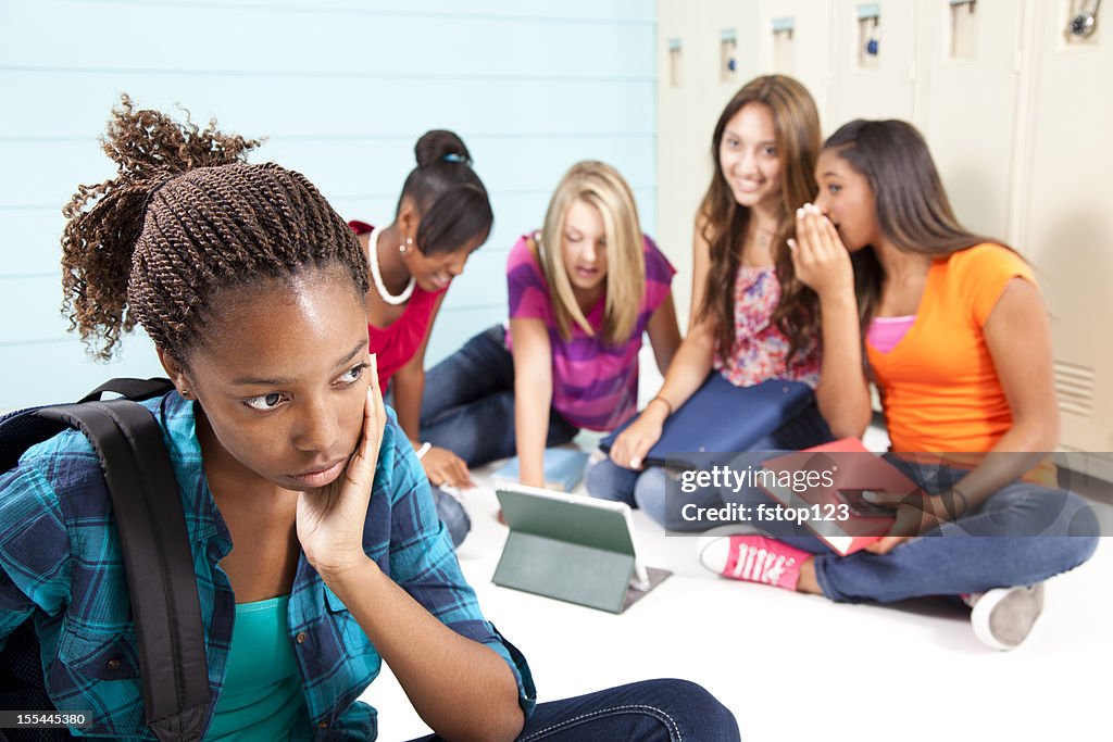 Teenager girls using internet technology. Cyber bully, harass classmate. School.