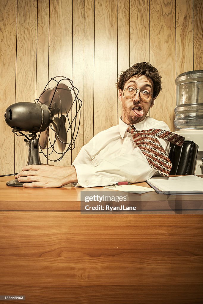 Business Man in Office With Fan