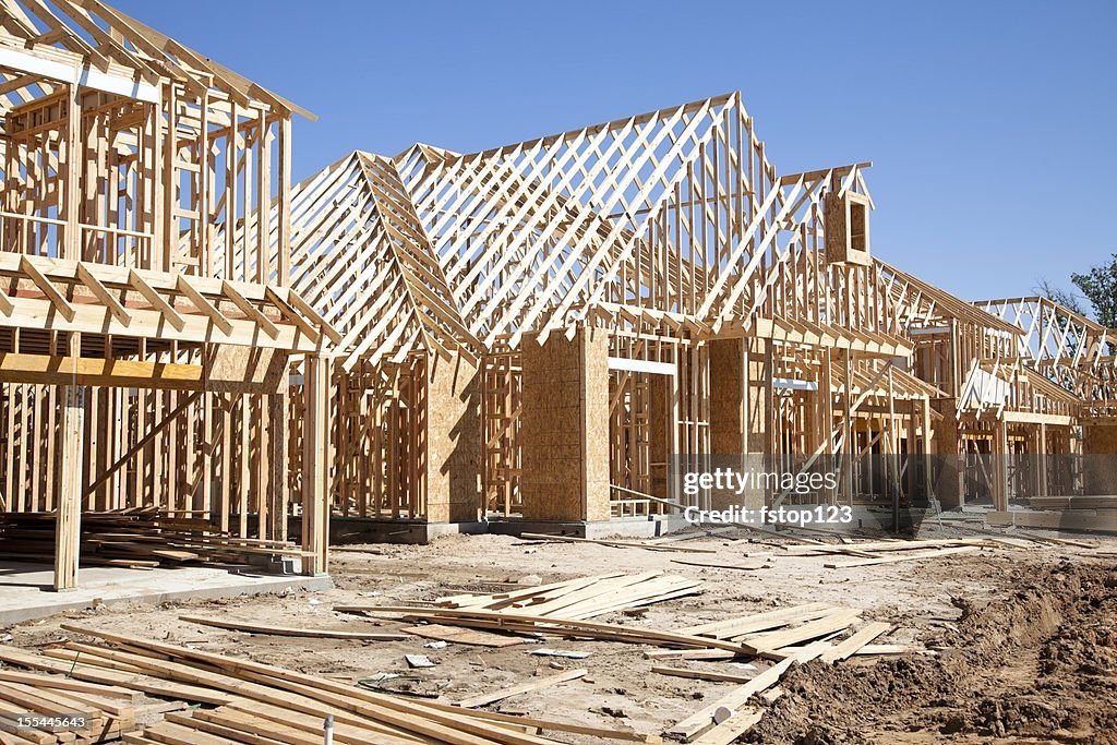 New homes construction site. Framed houses. Lumber. Building.