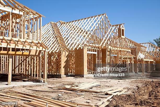 new homes construction site. framed houses. lumber. building. - bostadsområde bildbanksfoton och bilder