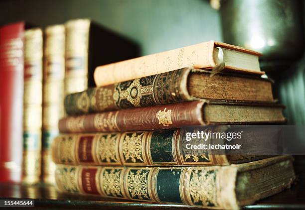 stack of antique books on a shelf - poetry stockfoto's en -beelden