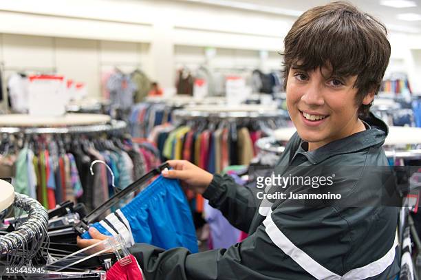teenage boy shopping - boy clothes stockfoto's en -beelden