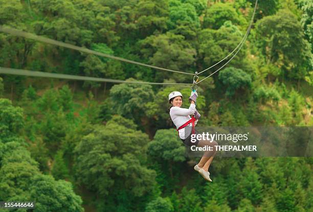 woman during a zip-line tour in guatemala - zipline stock pictures, royalty-free photos & images