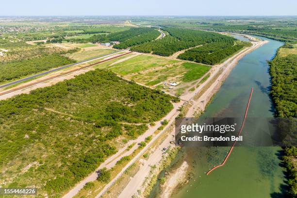 General drone view of the buoy barriers installed and situated in the middle of the Rio Grande river on July 18, 2023 in Eagle Pass, Texas. Texas has...