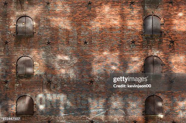 brick wall - new york city wall stock pictures, royalty-free photos & images