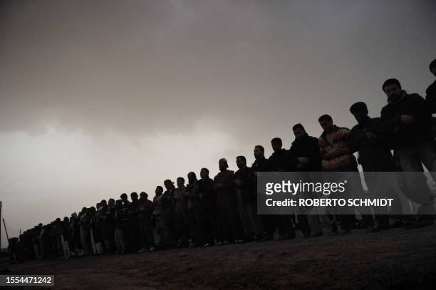 Libyans from the rebel-held eastern town of Brega pray following a rumor that fighters took over the town of Ras Lanuf from pro-Kadhafi forces during...