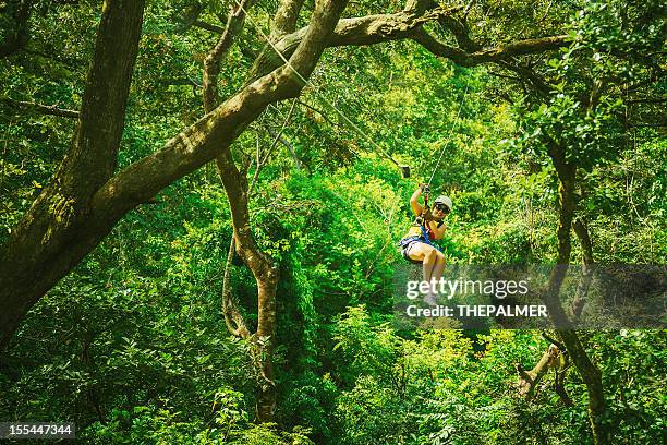 woman during a canopy tour costa rica - zip line stockfoto's en -beelden