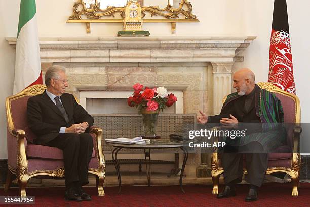 Italian Prime Minister Mario Monti speaks with Afghan President Hamid Karzai during a meeting in Kabul on November 4, 2012. Italian Prime Minister...