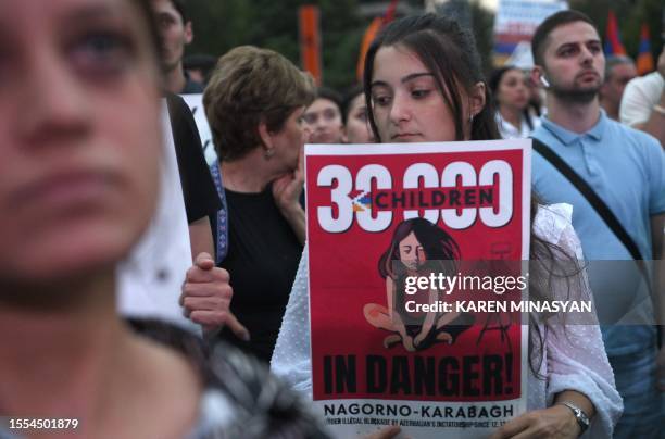 Demonstrators rally in support of Karabakh to demand the reopening of a blockaded road linking the Nagorno-Karabakh region to Armenia and to decry...