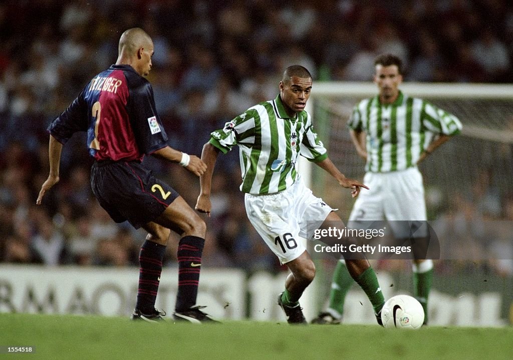 Denilson of Real Betis Michael Reiziger of Barcelona