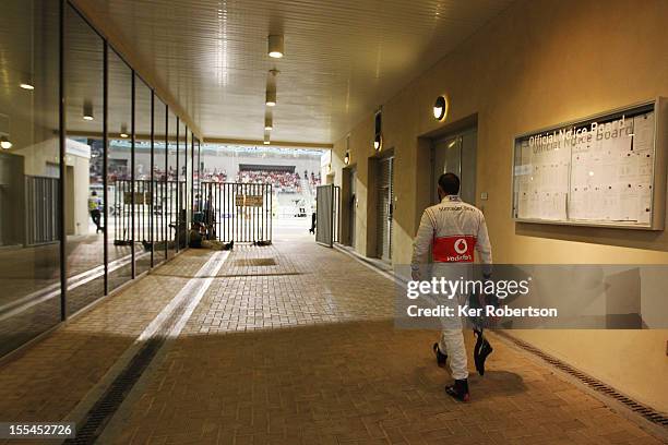 Lewis Hamilton of Great Britain and McLaren walks back to the pitlane after retiring early from the Abu Dhabi Formula One Grand Prix at the Yas...