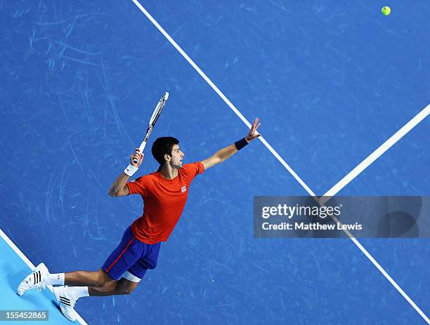Novak Djokovic of Serbai warms up against Juan Martin del Portro of Argentina during previews for the ATP World Tour Finals at the O2 Arena on...