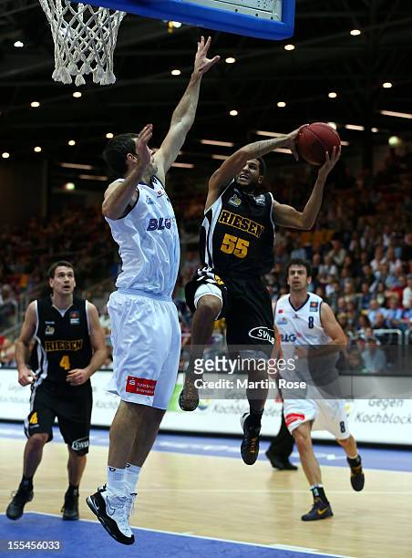 Keith Waleszkowski of Bremerhaven challenges for the ball with Joshua Jackson of Ludwigsburg during the Beko BBL basketball match between Eisbaeren...