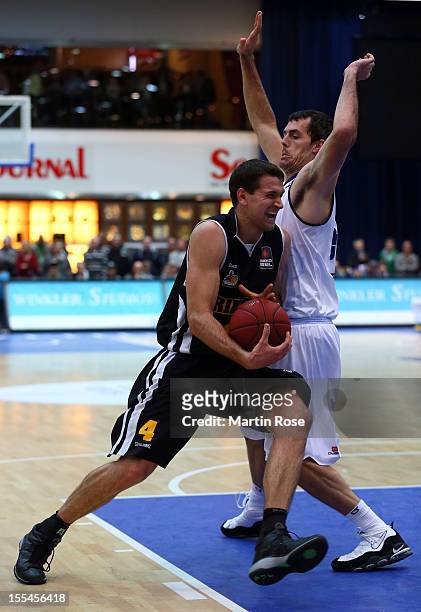 Keith Waleszkowski of Bremerhaven challenges for the ball with John Turek of Ludwigsburg during the Beko BBL basketball match between Eisbaeren...