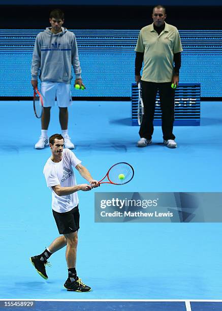 Andy Murray of Great Britain in action as his coach Ivan Lendl and hitting partner Daniel Vallverdu look on during previews for the ATP World Tour...