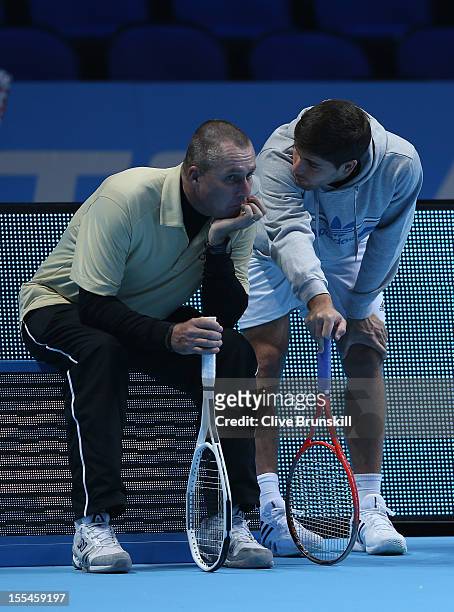 Andy Murray of Great Britain's coach Ivan Lendl and hitting partner Daniel Vallverdu discuss tatics during a practice session prior to the start of...