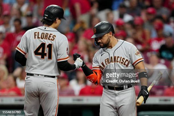 Wilmer Flores and Michael Conforto of the San Francisco Giants celebrate after Flores hit a home run in the first inning against the Cincinnati Reds...