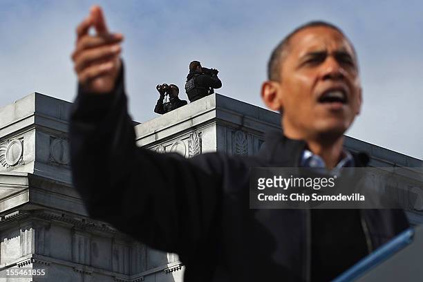 Secret Service counter-sniper team keeps an eye on State Capitol Square and the surrounding area as U.S. President Barack Obama addresses a campaign...