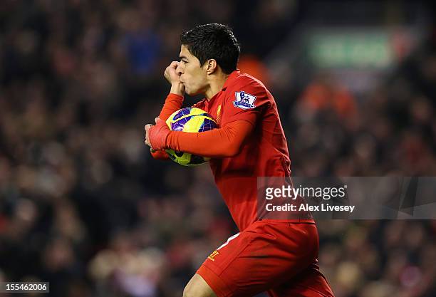 Luis Suarez of Liverpool celebrates scoring his team's first goal to make the score 1-1 during the Barclays Premier League match between Liverpool...