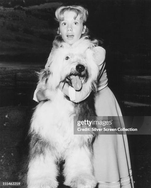 English actress Hayley Mills, with an Old English sheepdog, as Nancy Carey in 'Summer Magic', directed by James Neilson, 1963.