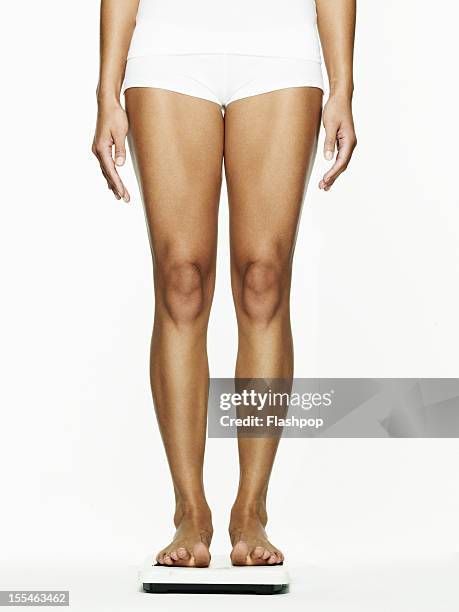 woman standing on weighing scales - body conscious bildbanksfoton och bilder