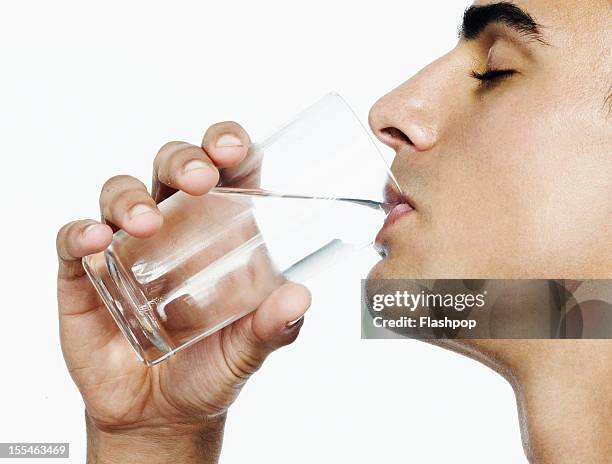 portrait of man drinking a glass of water - man drinking water fotografías e imágenes de stock