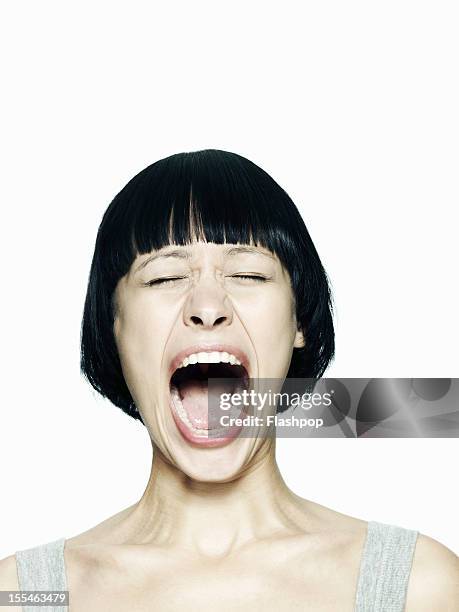 portrait of woman screaming - boca abierta fotografías e imágenes de stock