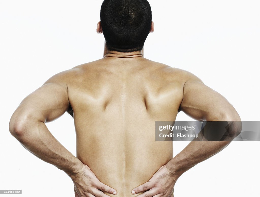 Man touching his back