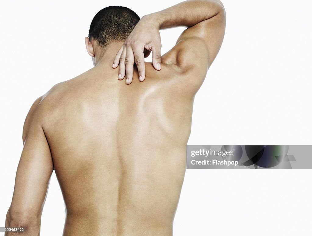 Man touching his shoulder