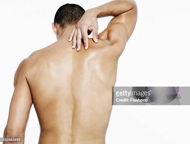 man touching his shoulder - dorsale foto e immagini stock